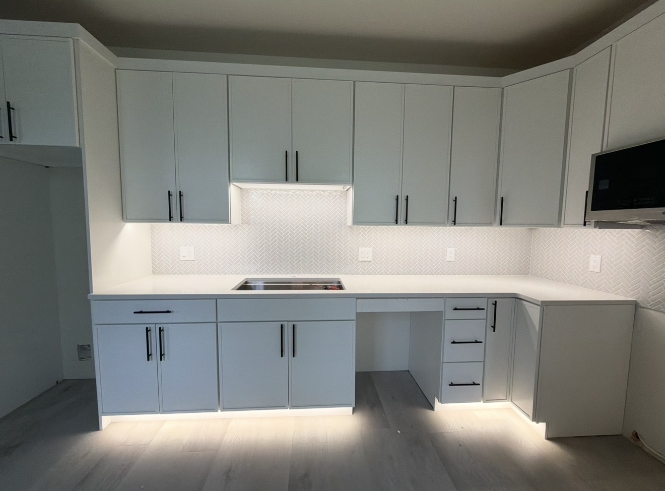 Residential kitchen with under-cabinet and toe-kick lighting by Brens Electric