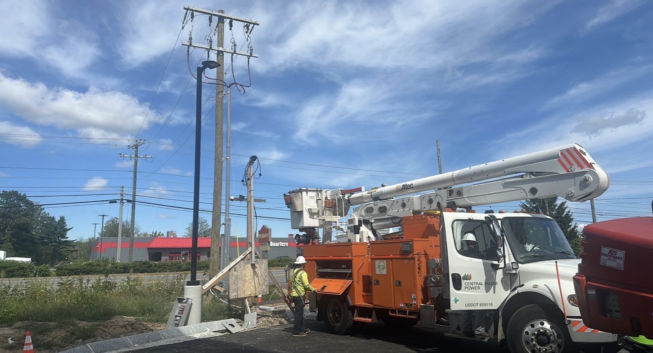 Serving utility crew coordinating overhead electrical service work for a Brens Electric project